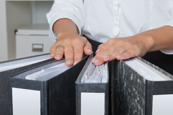 Hands of a woman on office files